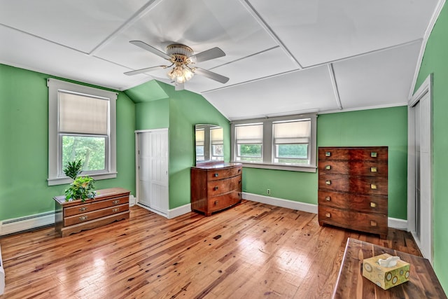 701 Augusta Rd, Winslow, ME 04901 - bedroom featuring vaulted ceiling, a baseboard radiator, wood-type flooring, a ceiling fan, and baseboards