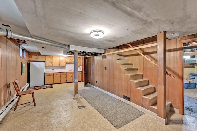 701 Augusta Rd, Winslow, ME 04901 - basement featuring freestanding refrigerator, wood walls, stairs, and baseboards