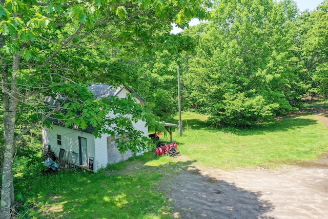 349 Veterans Hwy, Brooks, ME 04921 - view of grassy yard featuring dirt driveway and an outdoor structure