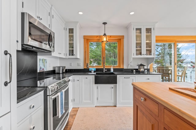 21 White Rd, Georgetown, ME 04548 - kitchen with white cabinetry, appliances with stainless steel finishes, a healthy amount of sunlight, and a sink