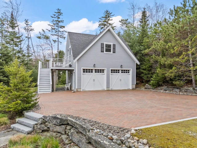 21 White Rd, Georgetown, ME 04548 - view of side of home featuring decorative driveway, roof with shingles, and stairs