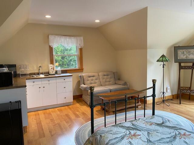 21 White Rd, Georgetown, ME 04548 - bedroom with light wood-style flooring, a sink, and vaulted ceiling
