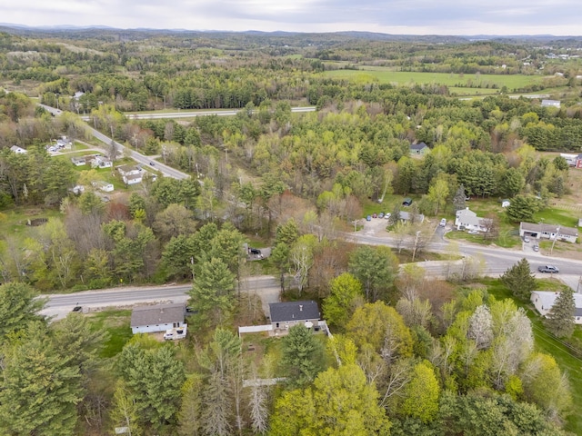 aerial view of property's location featuring a heavily wooded area