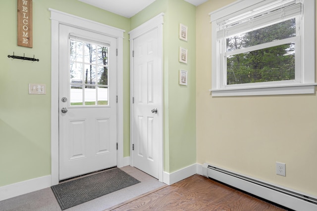 doorway with a baseboard radiator and baseboards