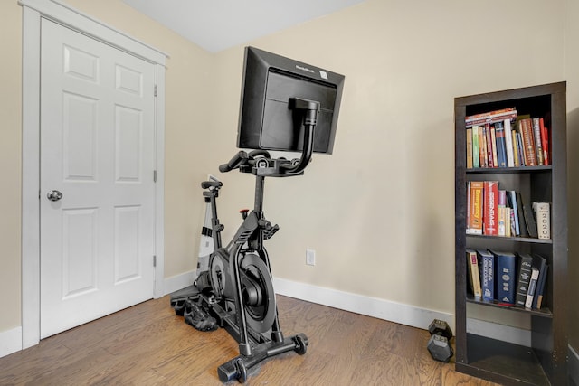 workout area with wood finished floors and baseboards