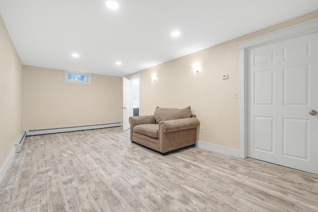 living area with a baseboard heating unit, wood finished floors, baseboards, and recessed lighting