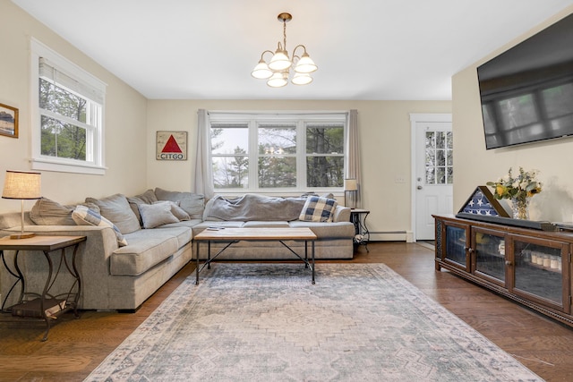 living area with a baseboard heating unit, a chandelier, and dark wood-type flooring