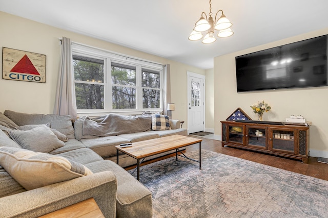 living area with a chandelier, wood finished floors, and baseboards