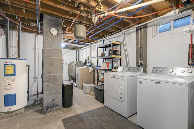 unfinished below grade area with electric water heater, independent washer and dryer, and oil tank