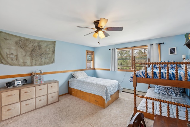 carpeted bedroom featuring baseboard heating, a ceiling fan, and baseboards