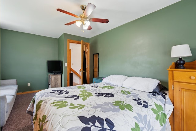 carpeted bedroom featuring baseboards and a ceiling fan