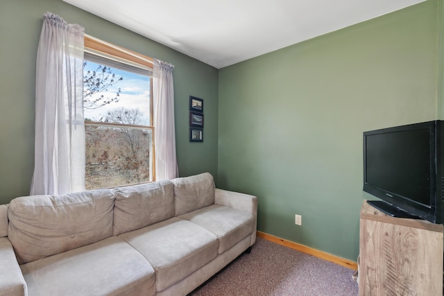 carpeted living area with baseboards