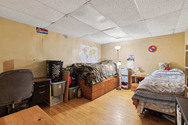 bedroom featuring hardwood / wood-style flooring and a paneled ceiling