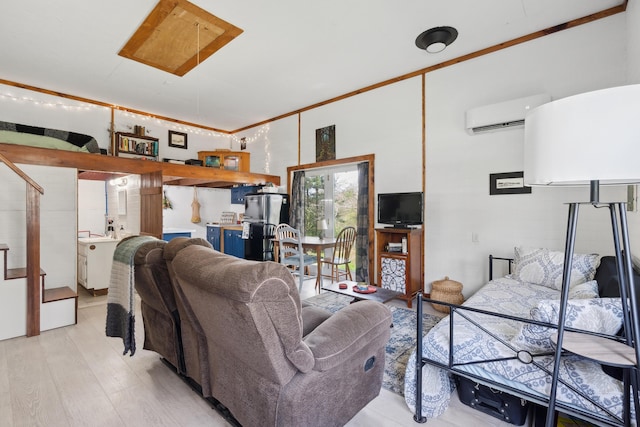 living room with an AC wall unit, light wood-style flooring, and crown molding
