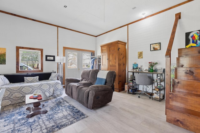living room with light wood finished floors and crown molding
