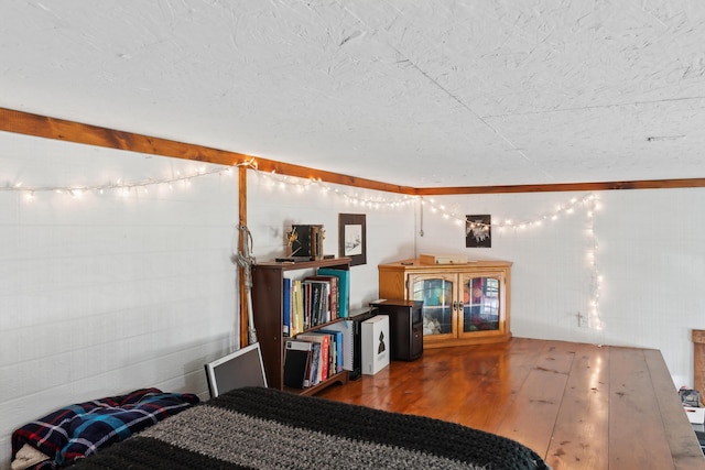 bedroom with wood finished floors and a textured ceiling