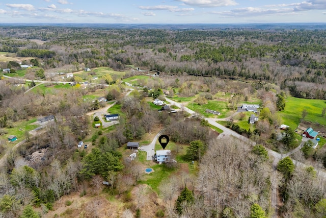 view of property location with a heavily wooded area