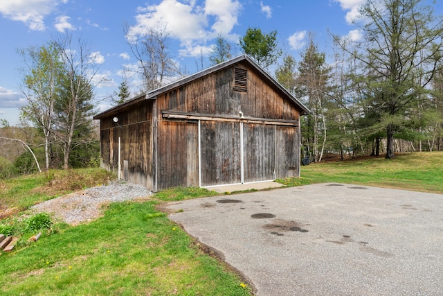 view of barn with a lawn