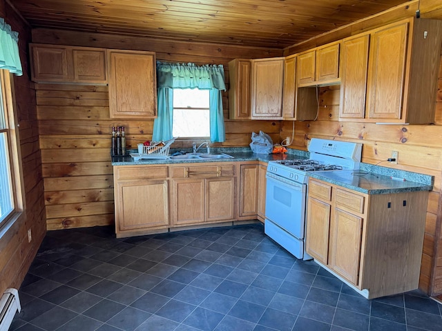 111 Fryes Ln, Greenbush, ME 04418 - kitchen featuring white range with gas cooktop, a sink, wood ceiling, wood walls, and baseboard heating