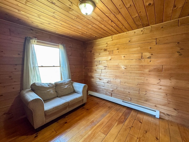 111 Fryes Ln, Greenbush, ME 04418 - sitting room with baseboard heating, wood ceiling, wood-type flooring, and wooden walls