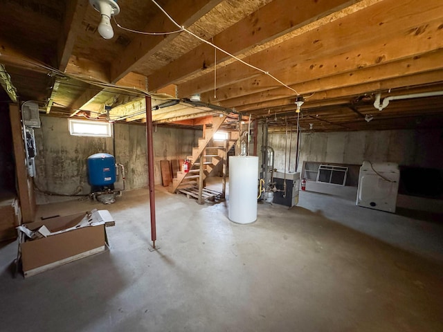 111 Fryes Ln, Greenbush, ME 04418 - below grade area featuring gas water heater, a water pressure tank, and stairway