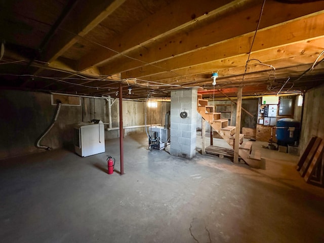 111 Fryes Ln, Greenbush, ME 04418 - unfinished below grade area with washer / dryer, stairs, a water pressure tank, and electric panel