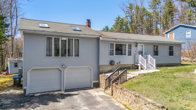 48 Albion Rd, Windham, ME 04062 - view of front of property with a garage, a chimney, driveway, and a front yard