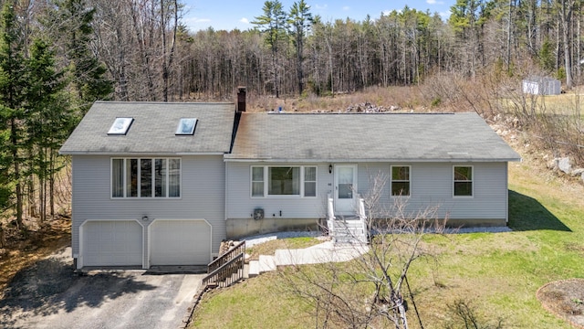 48 Albion Rd, Windham, ME 04062 - view of front of home with an attached garage, driveway, a chimney, a front yard, and a forest view