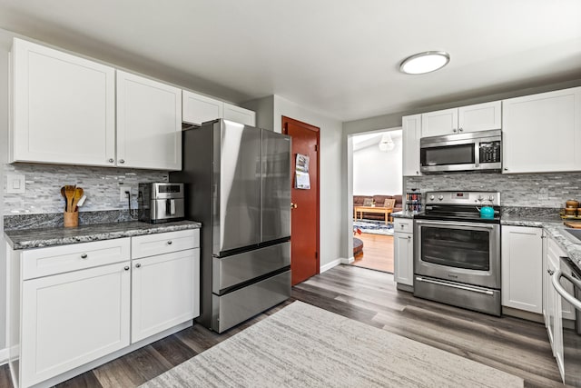 48 Albion Rd, Windham, ME 04062 - kitchen featuring appliances with stainless steel finishes, decorative backsplash, dark wood finished floors, and white cabinetry
