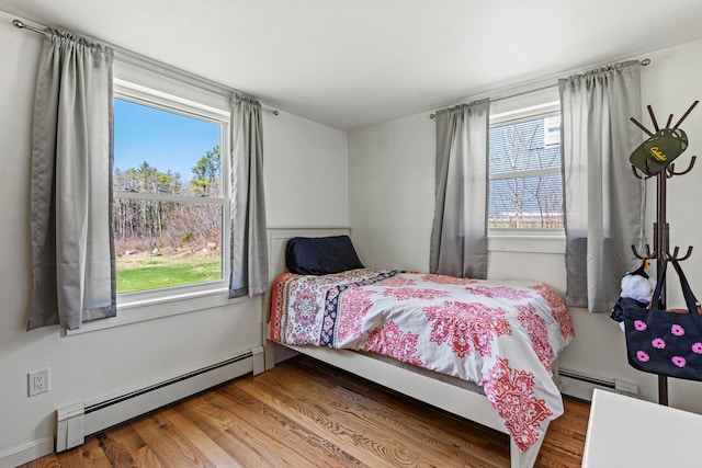 48 Albion Rd, Windham, ME 04062 - bedroom with a baseboard heating unit and wood finished floors