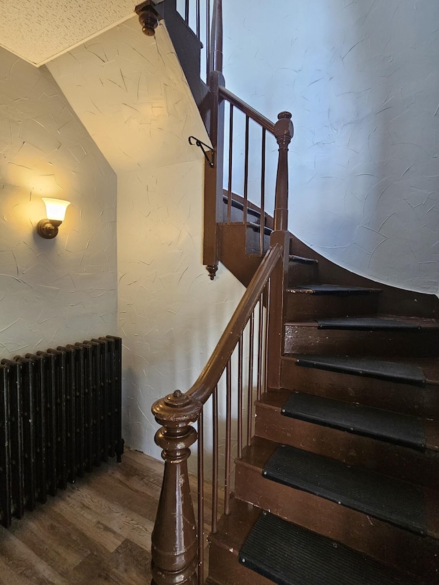 stairway featuring wood finished floors