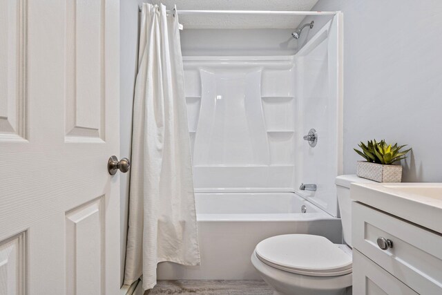 full bathroom featuring toilet, shower / bathtub combination with curtain, and vanity