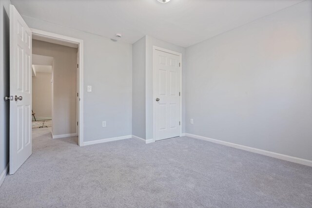 unfurnished bedroom with carpet and baseboards
