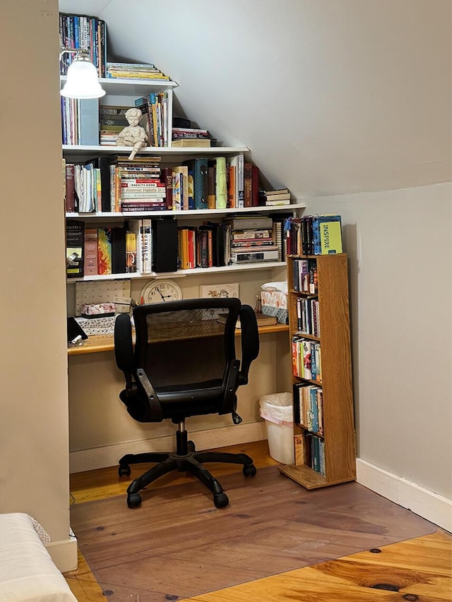 office with vaulted ceiling, baseboards, and wood finished floors