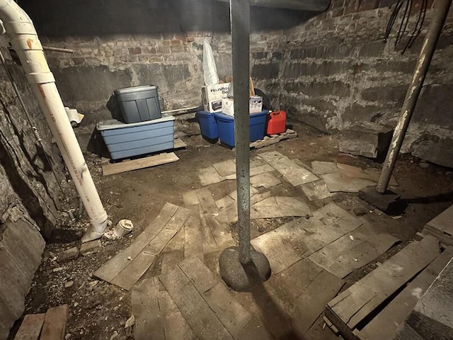 unfinished below grade area featuring concrete block wall