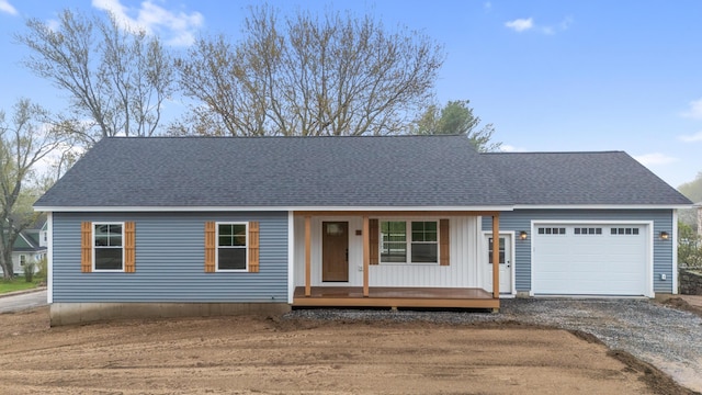 26 June St, Sanford, ME 04073 - view of front facade with a porch, driveway, a garage, and roof with shingles