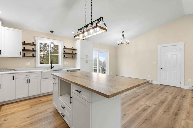 26 June St, Sanford, ME 04073 - kitchen with open shelves, a sink, light wood-style floors, white cabinets, and vaulted ceiling