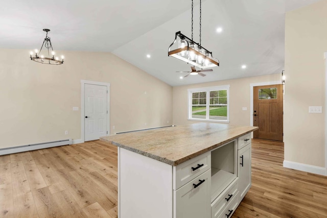26 June St, Sanford, ME 04073 - kitchen featuring light wood-type flooring, white cabinets, a chandelier, a kitchen island, and baseboard heating