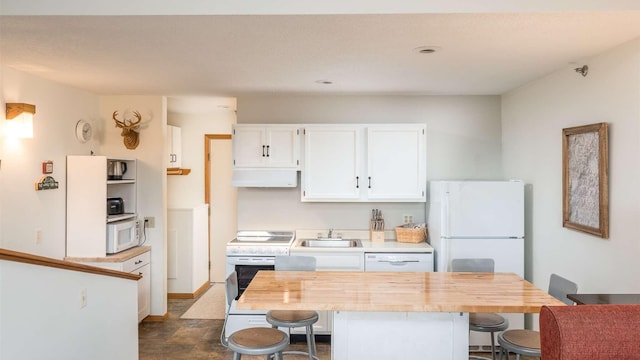 8 Sunrise Dr Unit A115, Newry, ME 04261 - kitchen featuring a breakfast bar area, a sink, white cabinetry, white appliances, and under cabinet range hood