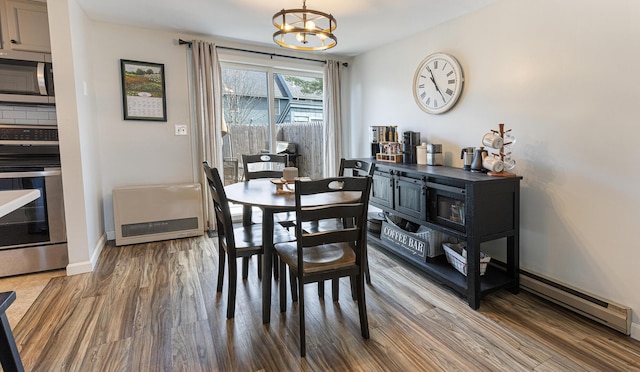 8 Orchard Hills Pkwy Unit 8, Bangor, ME 04401 - dining area featuring wood finished floors, a chandelier, baseboards, and heating unit