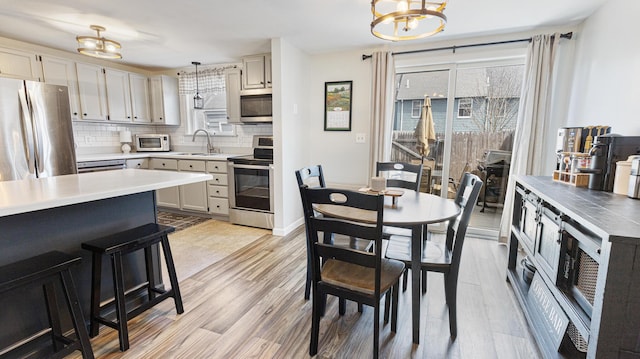 8 Orchard Hills Pkwy Unit 8, Bangor, ME 04401 - kitchen with appliances with stainless steel finishes, a chandelier, a sink, and plenty of natural light