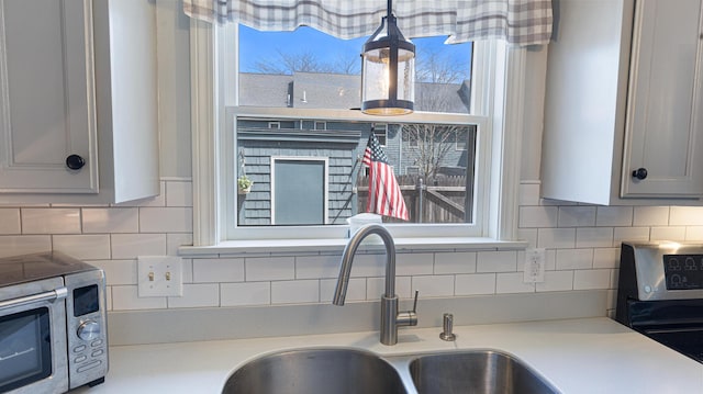 8 Orchard Hills Pkwy Unit 8, Bangor, ME 04401 - kitchen view of a sink, backsplash, light countertops, and electric range