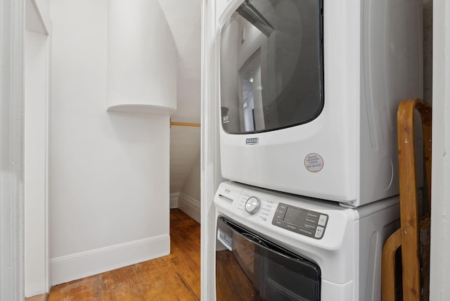 17 Pine St Unit 1, Portland, ME 04102 - washroom with estacked washer and dryer, wood finished floors, and baseboards