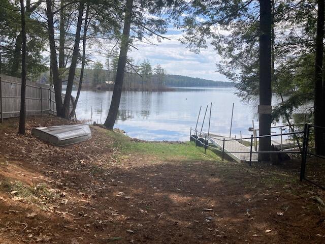 view of yard featuring a water view and fence