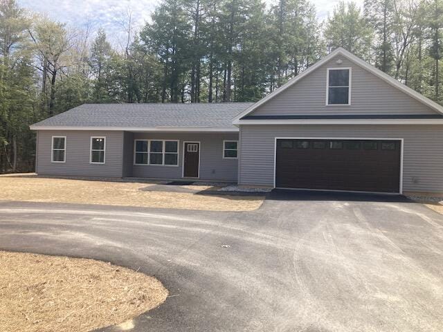 ranch-style house featuring driveway and a garage