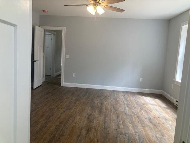 empty room with baseboards, ceiling fan, and wood finished floors