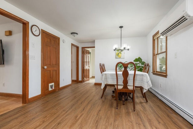 784 Ocean Ave, Portland, ME 04103 - dining room featuring baseboard heating, a wall mounted AC, light wood finished floors, a chandelier, and baseboards