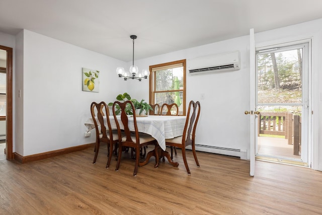784 Ocean Ave, Portland, ME 04103 - dining area featuring an AC wall unit, baseboard heating, plenty of natural light, and light wood finished floors