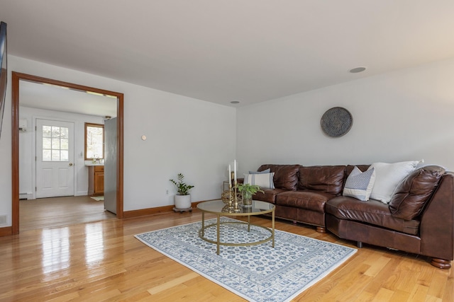 784 Ocean Ave, Portland, ME 04103 - living room featuring light wood-type flooring, a baseboard heating unit, and baseboards