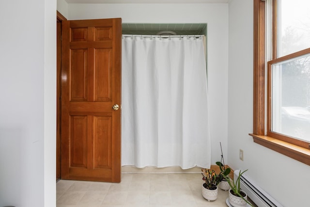 784 Ocean Ave, Portland, ME 04103 - full bath with baseboard heating and a shower with curtain
